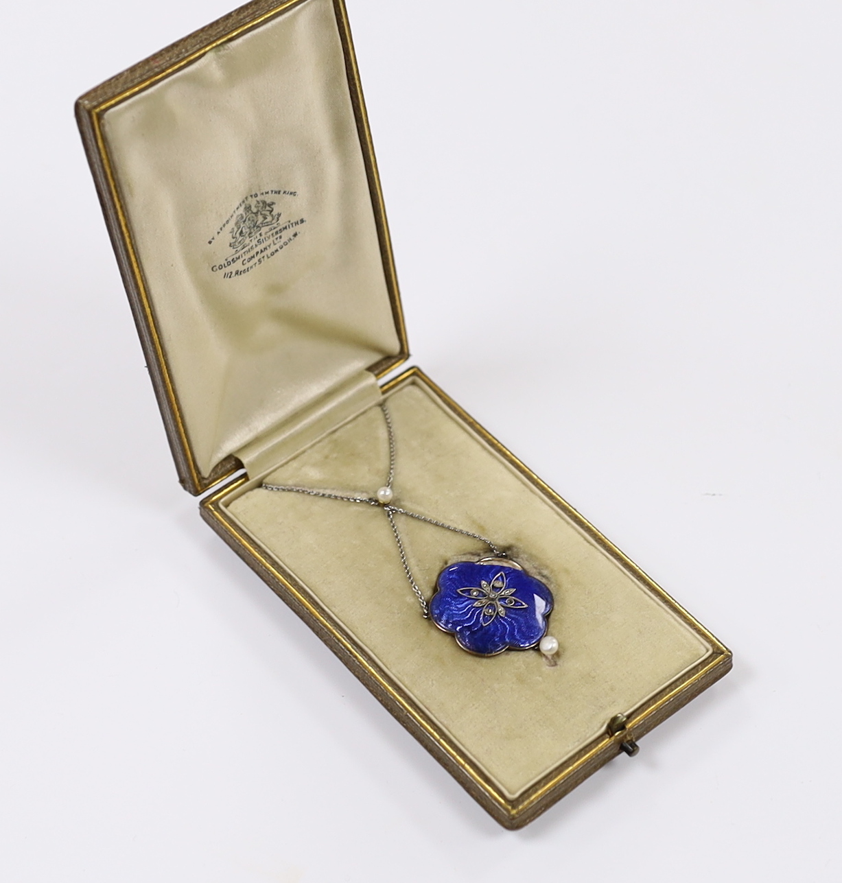 An Edwardian white metal, enamel, seed pearl and rose cut diamond chip set drop pendant necklace, overall 47cm (a.f.)